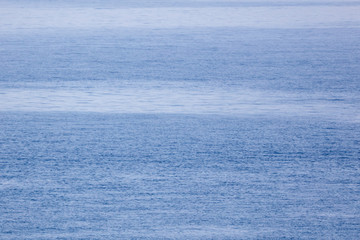 Blue expanse of water at sea as abstract background