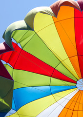 A multi-colored dome of a parachute in the sky as a background