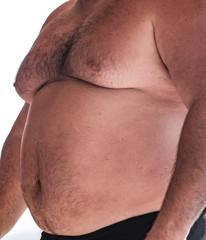 Naklejka premium Big belly of a fat man on the beach