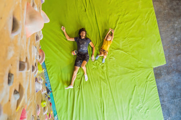 Dad and son at the climbing wall. Family sport, healthy lifestyle, happy family
