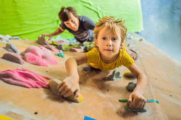 Dad and son at the climbing wall. Family sport, healthy lifestyle, happy family