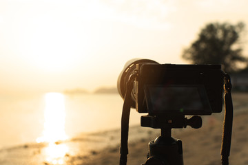 Camera recording time lapse the seascape during sunset.