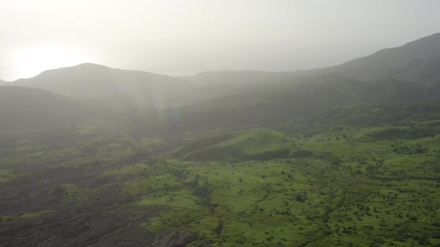 Smooth dolly forward type shot. Vash open grassy, mountainous landscape. Almost dream-like