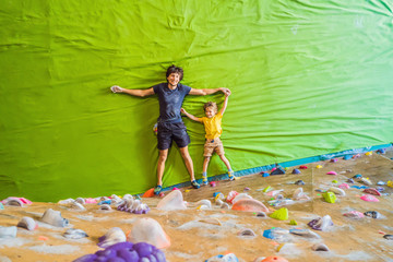 Dad and son at the climbing wall. Family sport, healthy lifestyle, happy family