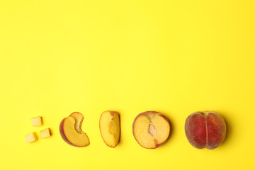 Flat lay composition with ripe peaches on yellow background, space for text