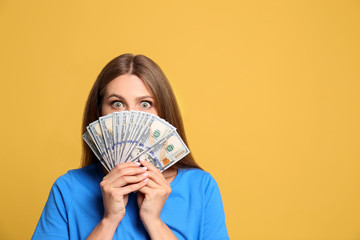 Portrait of happy lottery winner with money on yellow background, space for text