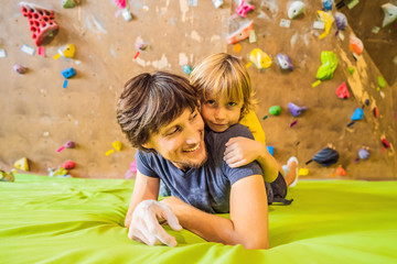 Dad and son at the climbing wall. Family sport, healthy lifestyle, happy family