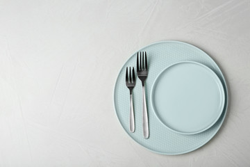 Beautiful table setting on grey background, top view. Space for text