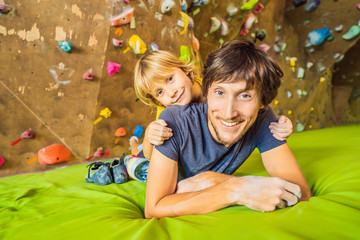 Dad and son at the climbing wall. Family sport, healthy lifestyle, happy family