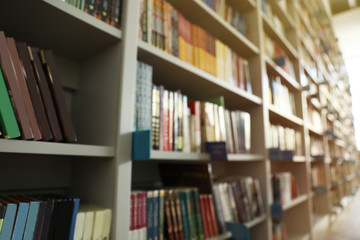 Blurred view of shelves with books in library
