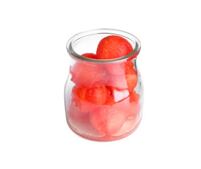 Glass jar of watermelon balls on white background