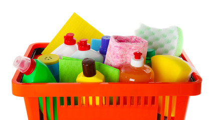 Shopping basket full of detergents on white background