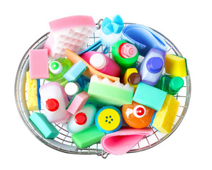 Shopping basket with different detergents on white background, top view
