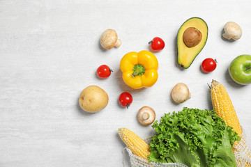 Fresh vegetables on light grey background, flat lay. Space for text