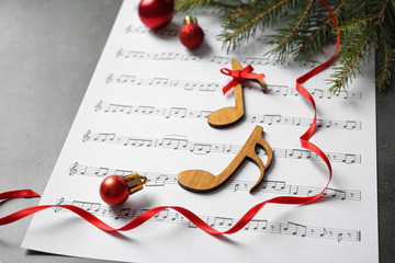Christmas decorations, notes and music sheet on grey stone table