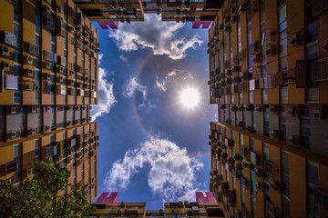 Natural phenomenon Sun halo over high building in city