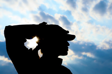 Female soldier in uniform saluting outdoors. Military service