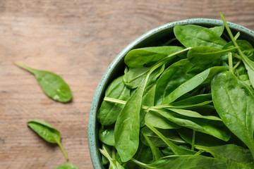 Fresh green healthy spinach on wooden table, top view