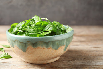Fresh green healthy spinach on wooden table