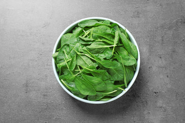 Fresh green healthy spinach on grey table, top view