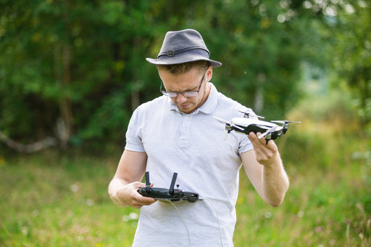 The young man manipulates the drone using the control panel. New technologies and trends in photo and video recording. record footage in the air.