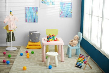 Baby room interior with color furniture and toys