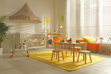 Cozy baby room interior with comfortable crib