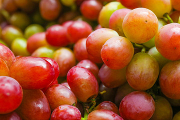 Fototapeta na wymiar Fresh ripe juicy red grapes as background, closeup view
