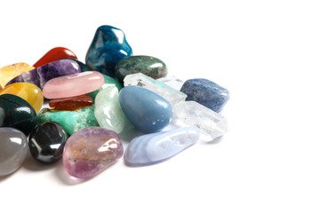 Pile of different beautiful gemstones on white background