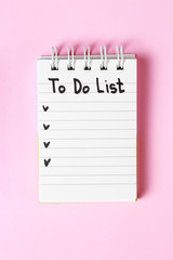 To Do List in notebook on pink background, copy space, planning concept