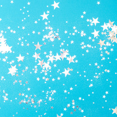 Light blue background with many shiny stars.