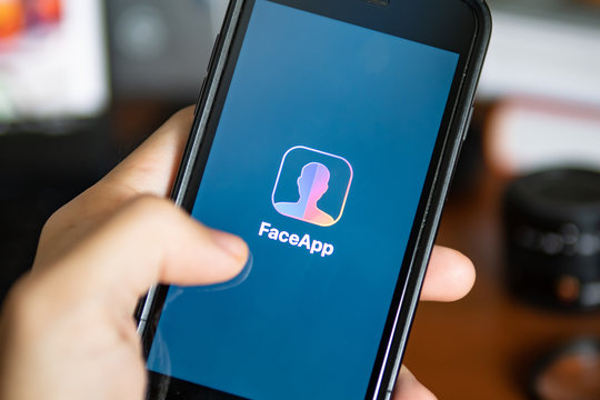 Bangkok, Thailand - July 18, 2019 : iPhone 7 showing its screen with FaceApp - AI Face Editor application.