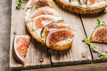 Sandwich with figs, cheese, honey and thyme. Selective focus. Shallow depth of field.