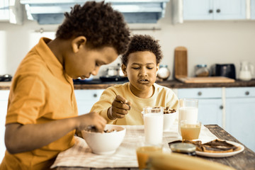 Fototapeta na wymiar Cereals and milk - wholesome breakfast for two little boys.
