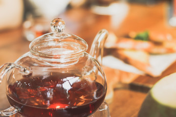 teapot at a cafe blurred background and garlic bread.