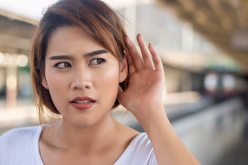 sad woman listening to bad news or suffering from hear of hearing ear, hearing loss