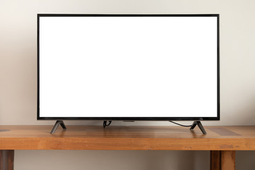 Naklejka premium blank screen television on wooden table at living room.