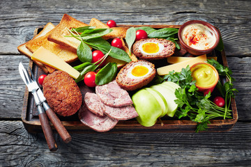 ploughman's lunch on a wooden board, close-up