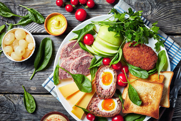 ploughman's lunch on a white platter, close-up