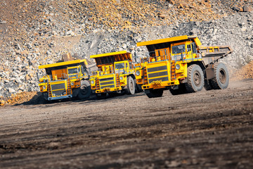 Open pit mine industry. Big yellow mining truck for coal moving on road career