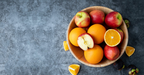 Fototapeta na wymiar high vitamin c fruits on wooden plate, apple and orange fruit.
