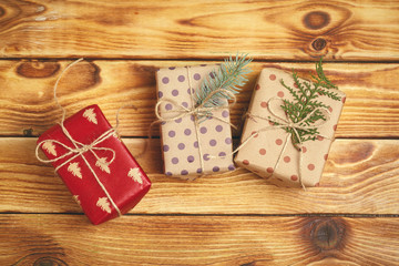 Small christmas gifts on wooden background, view from above