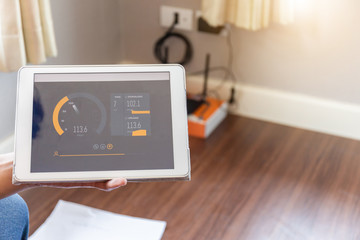 Internet technician man showing speedtest upload and download with tablet, Home IT network concept