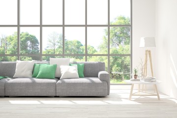 Stylish room in white color with sofa and summer landscape in window. Scandinavian interior design. 3D illustration
