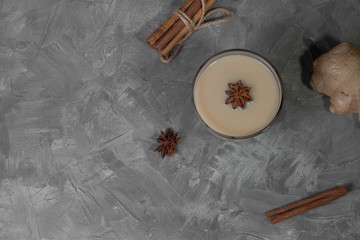 Traditional indian masala chai tea with ingredients. Cinnamon, cardamom, anise, ginger. Top view with copy space.