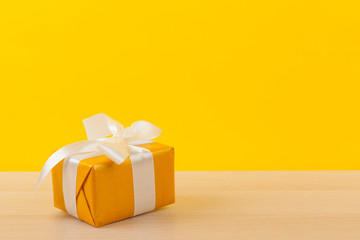 Gifts with ribbons on bright yellow background