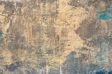 Textuur van een betonnen muur met scheuren en krassen die als achtergrond kunnen worden gebruikt