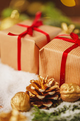 Decorated present on snowy wooden table close up
