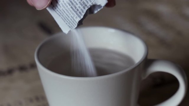 Pouring powder in hot water, to cure illness or sweeten the drink with sugar concept.