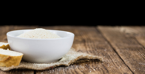 Vintage wooden table with Bread Crumbs (selective focus; close-up shot)